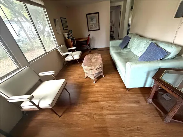 a living room with furniture rug and a window