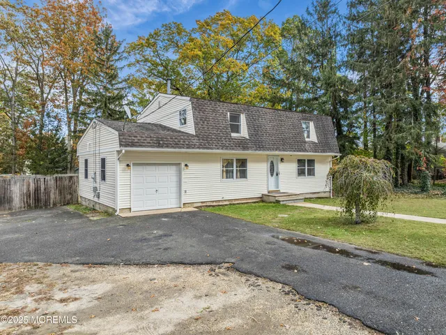 a front view of house with yard and trees