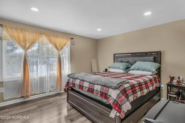 a bed sitting in a bedroom next to a window