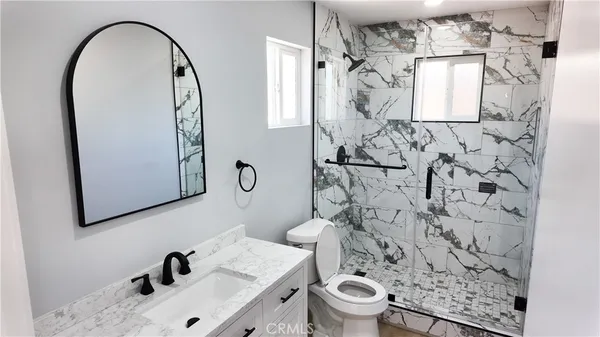 a bathroom with a sink toilet and mirror