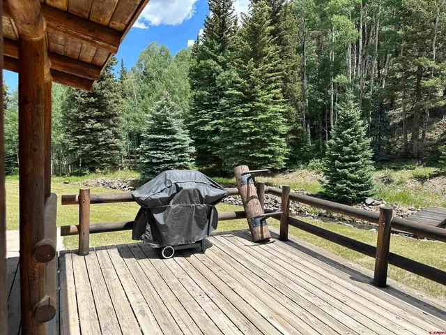 a view of a balcony with chairs and wooden floor