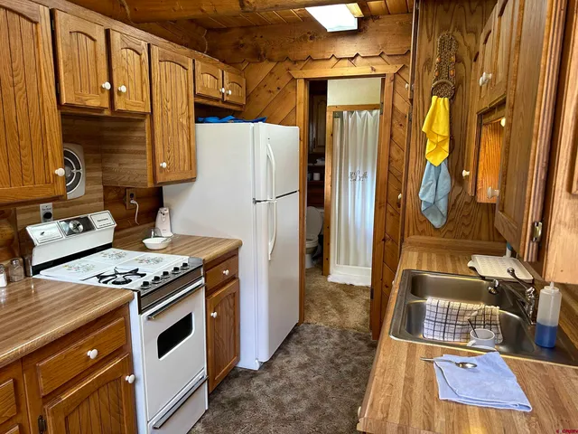 a kitchen that has a stove and a table