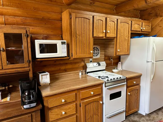 a kitchen with stainless steel appliances a stove a microwave and a refrigerator