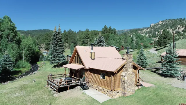 an aerial view of a chairs and table in the garden