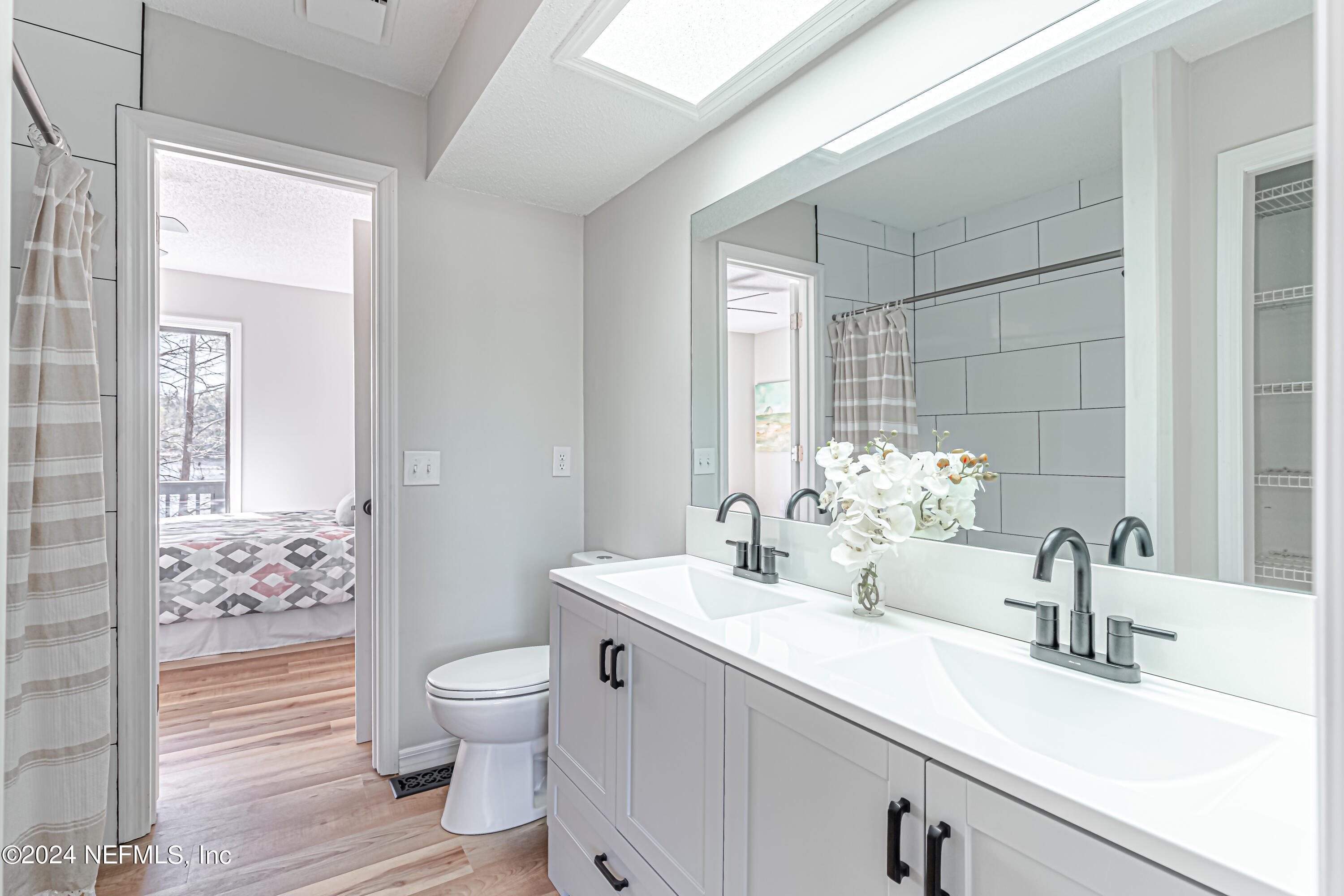 565 Roberts Road St. Johns, FL 32259 - Photo 37 of 79 a bathroom with a toilet a sink and mirror
