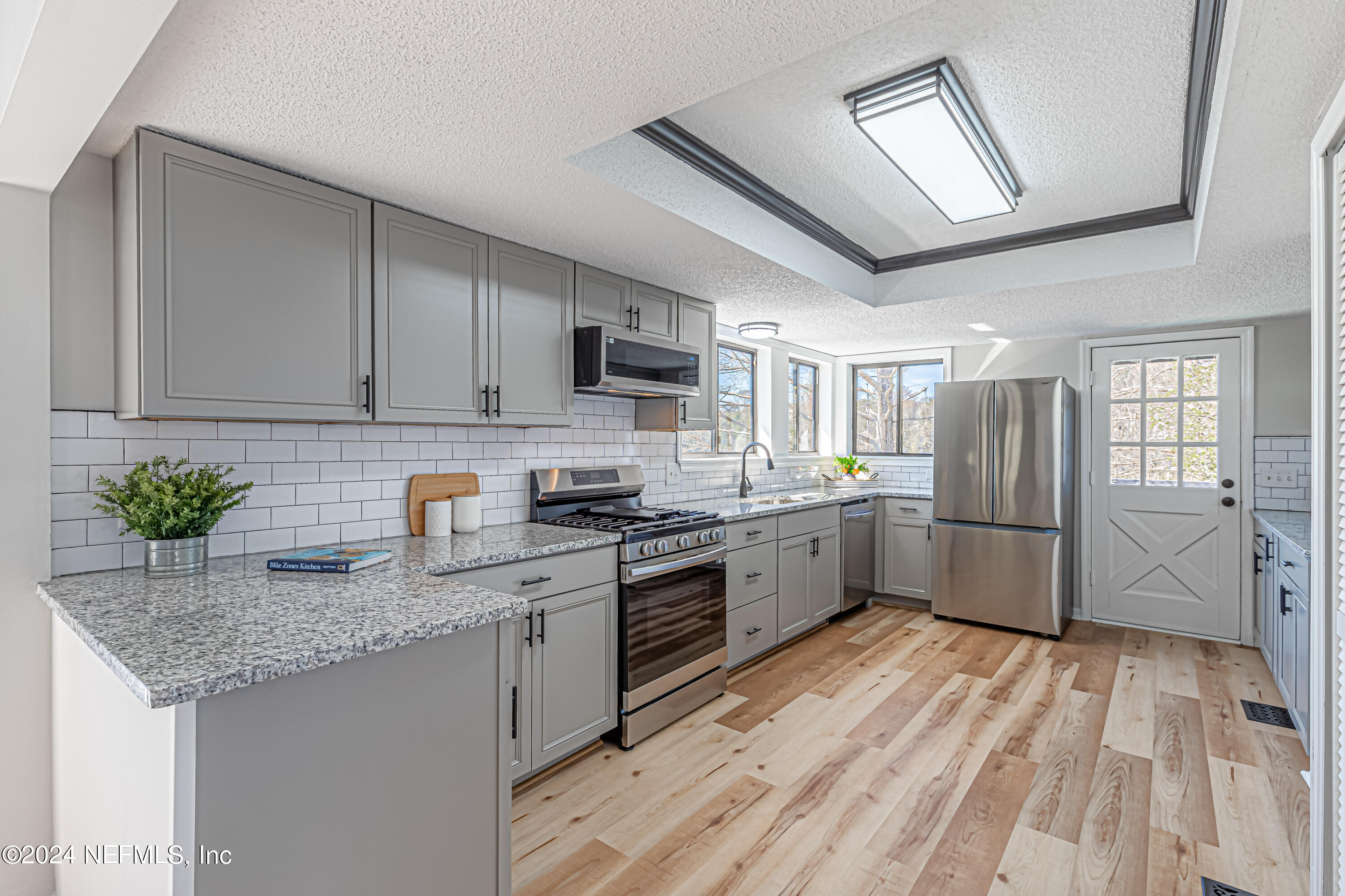 565 Roberts Road St. Johns, FL 32259 - Photo 5 of 79 a kitchen with stainless steel appliances granite countertop a stove refrigerator sink and cabinets