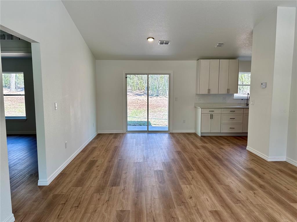 8601 North Stern Drive Citrus Springs, FL 34434 - Photo 3 of 18 wooden floor in an empty room with a window