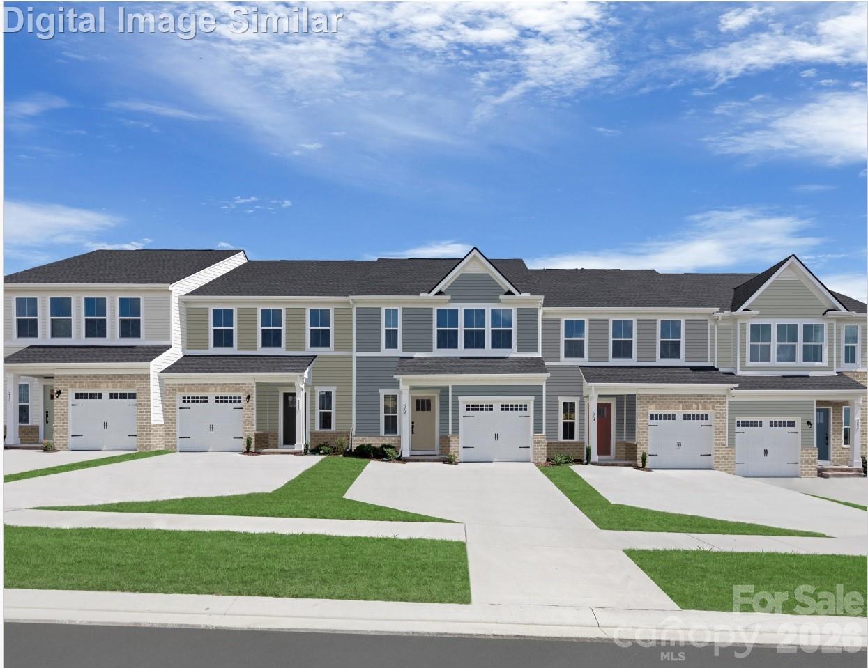 9569 Teamwork Street Northwest Concord, NC 28027 - Photo 1 of 23 a front view of residential houses with yard and green space