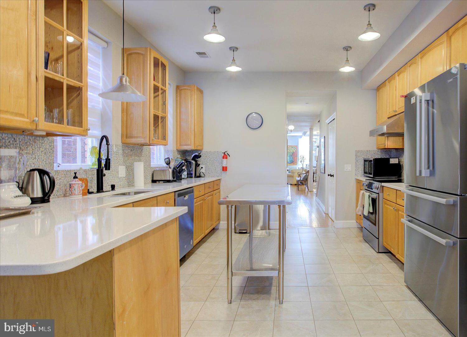 1118 F Street Northeast Washington, DC 20002 - Photo 11 of 62 a kitchen with stainless steel appliances granite countertop a sink a stove and a refrigerator