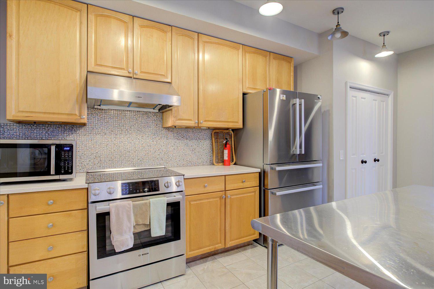 1118 F Street Northeast Washington, DC 20002 - Photo 13 of 62 a kitchen with stainless steel appliances granite countertop a refrigerator sink and cabinets