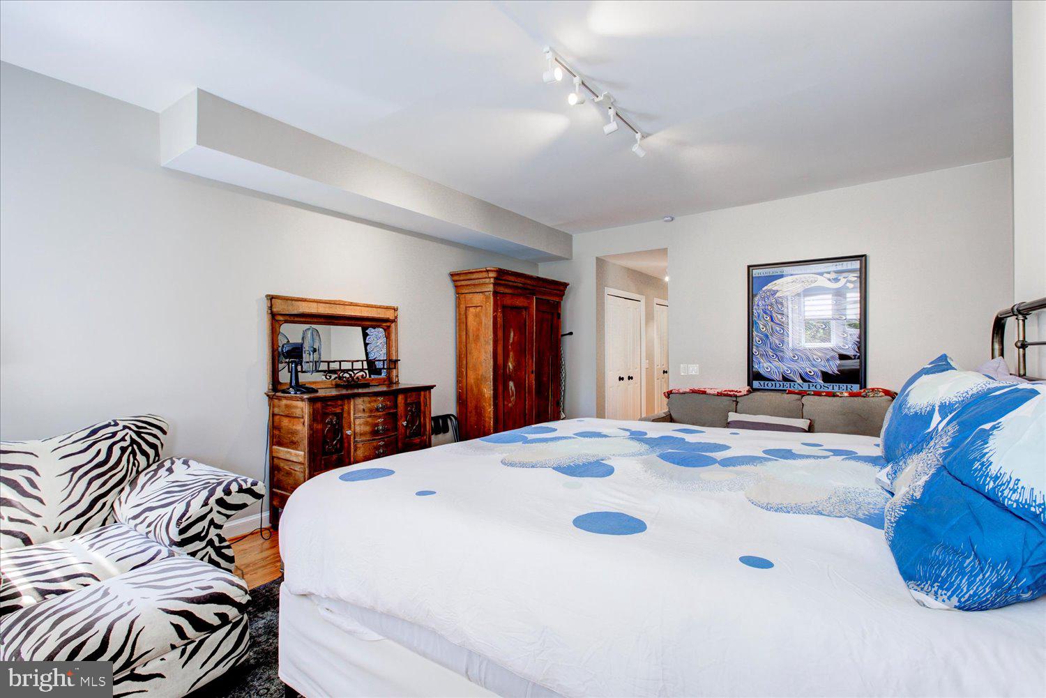 1118 F Street Northeast Washington, DC 20002 - Photo 19 of 62 a bedroom with a bed and a chandelier