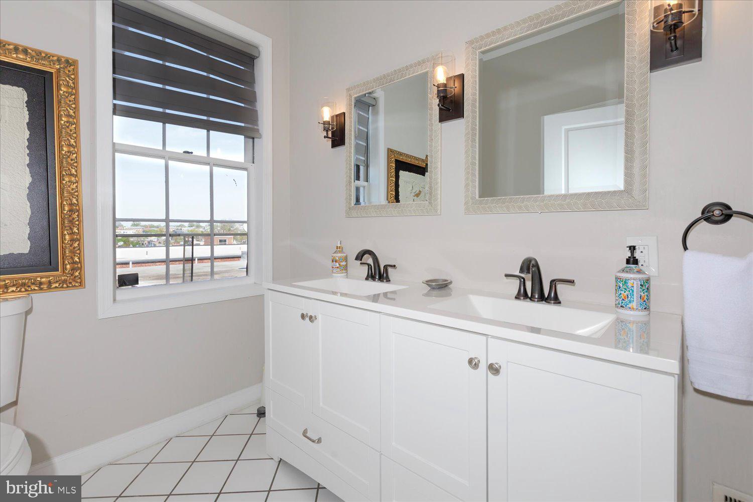 1118 F Street Northeast Washington, DC 20002 - Photo 21 of 62 a bathroom with a sink and a mirror