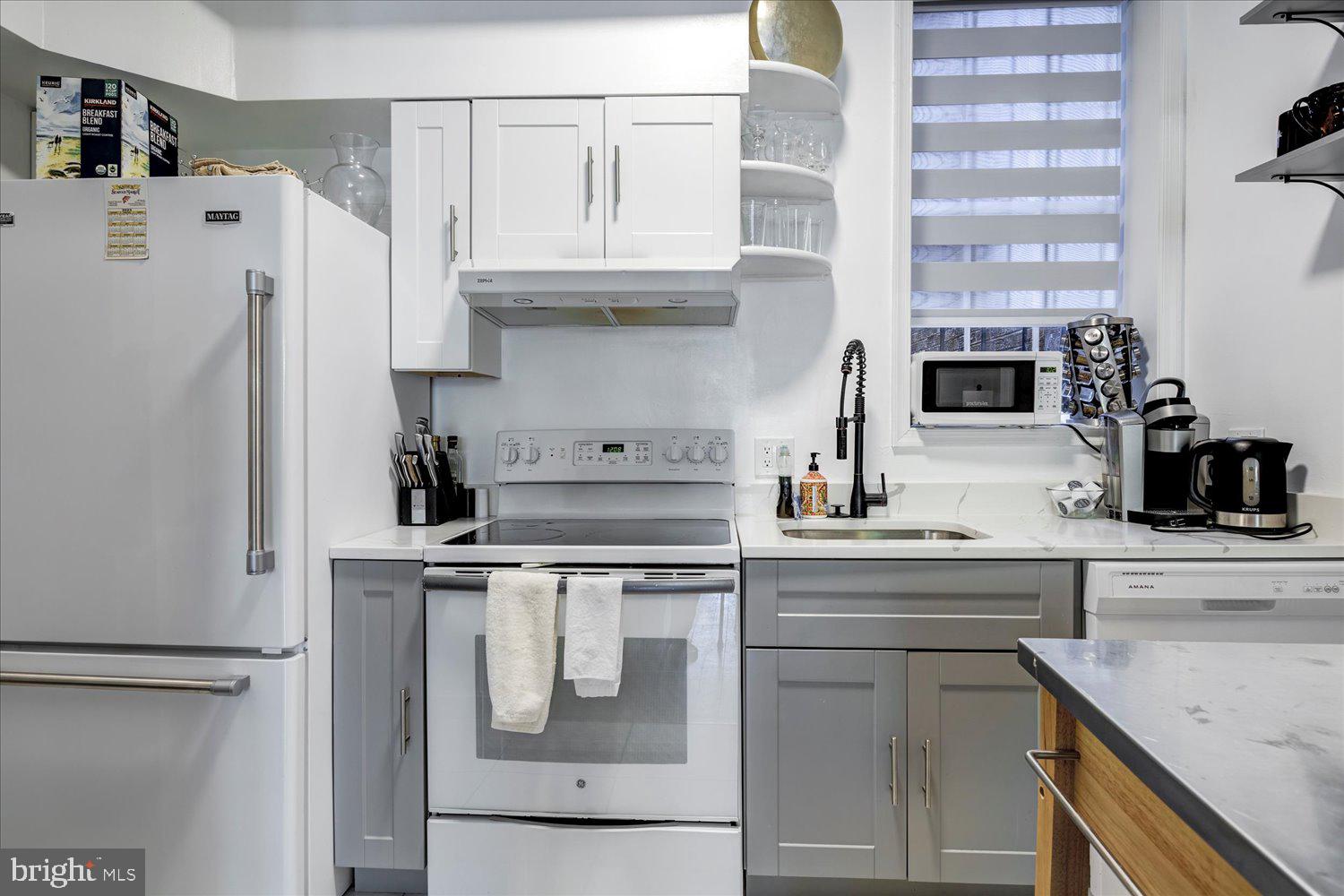 1118 F Street Northeast Washington, DC 20002 - Photo 37 of 62 a kitchen with stainless steel appliances granite countertop a refrigerator and a stove