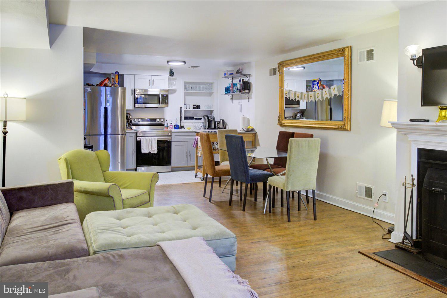 1118 F Street Northeast Washington, DC 20002 - Photo 50 of 62 a living room with furniture and a flat screen tv