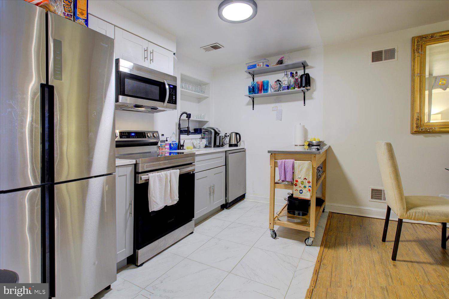 1118 F Street Northeast Washington, DC 20002 - Photo 55 of 62 a kitchen with stainless steel appliances a refrigerator stove and a sink