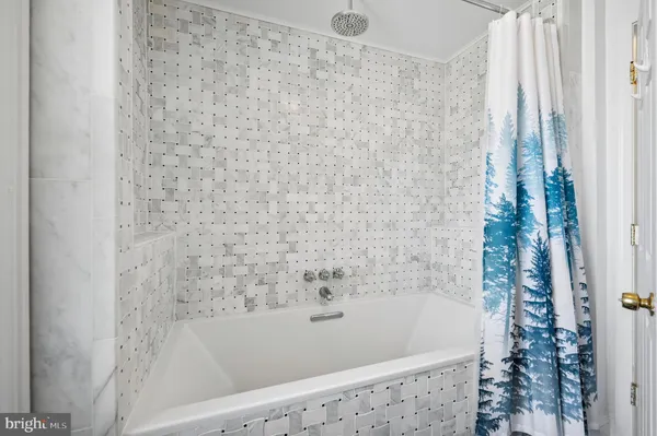 a bathroom with a bathtub and shower