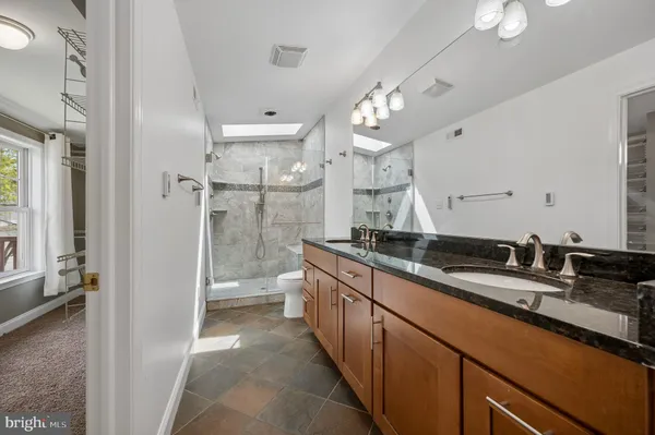 a bathroom with a double vanity sink and a mirror