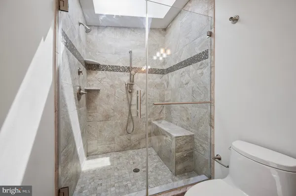 a bathroom with a shower and toilet