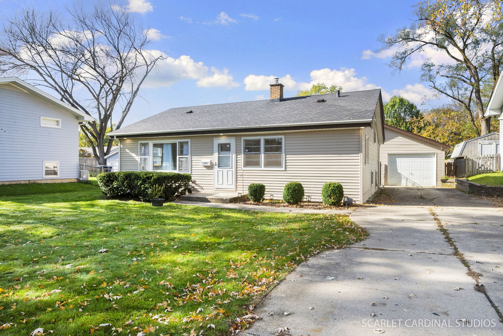1445 North Webster Street Naperville, IL 60563 - Photo 2 of 16 a front view of a house with a yard and garage