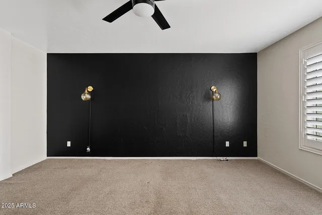 a view of empty room with ceiling fan