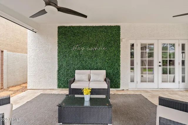 a view of a house with backyard and a tree