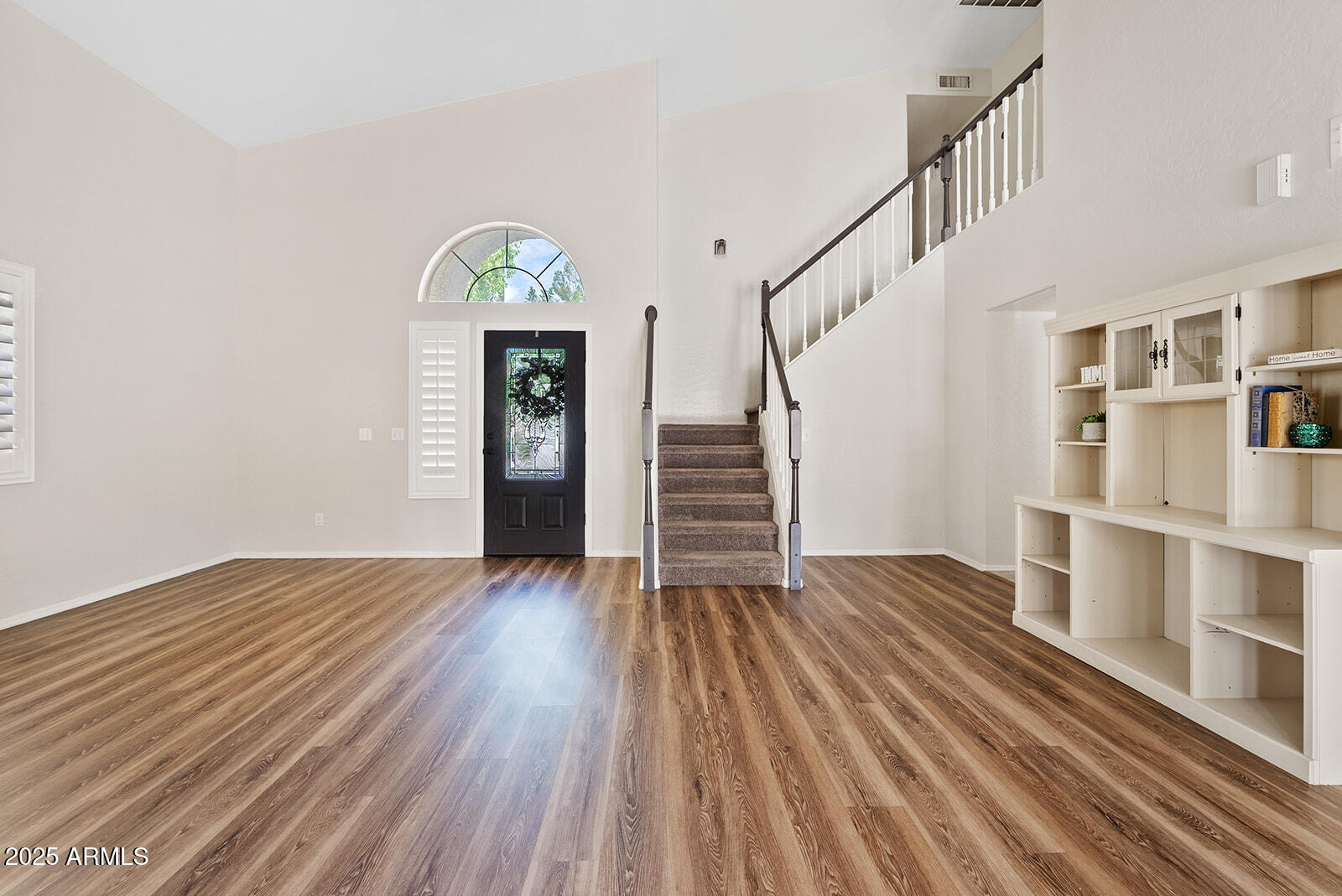 861 West Shellfish Drive Gilbert, AZ 85233 - Photo 7 of 32 a view of empty room with stairs and wooden floor