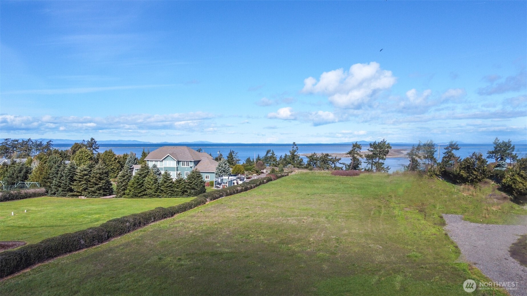 9999 Marine Drive Sequim, WA 98382 - Photo 3 of 20 a view of a pathway both side of grassy field with shrub