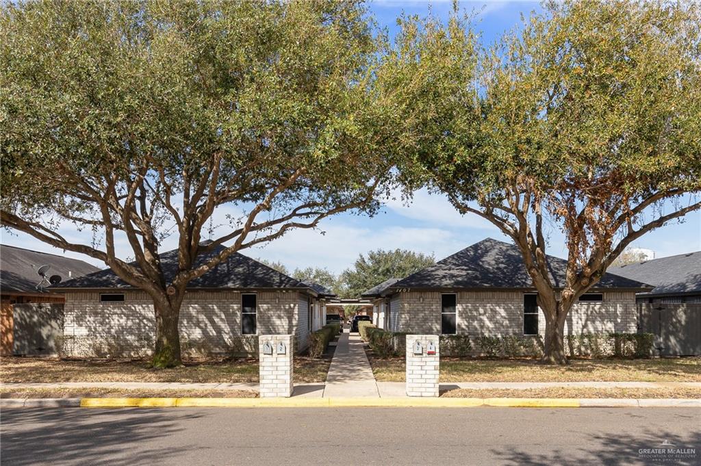 1107 Lexington Circle Edinburg, TX 78539 - Photo 1 of 1 a house with trees in front of it