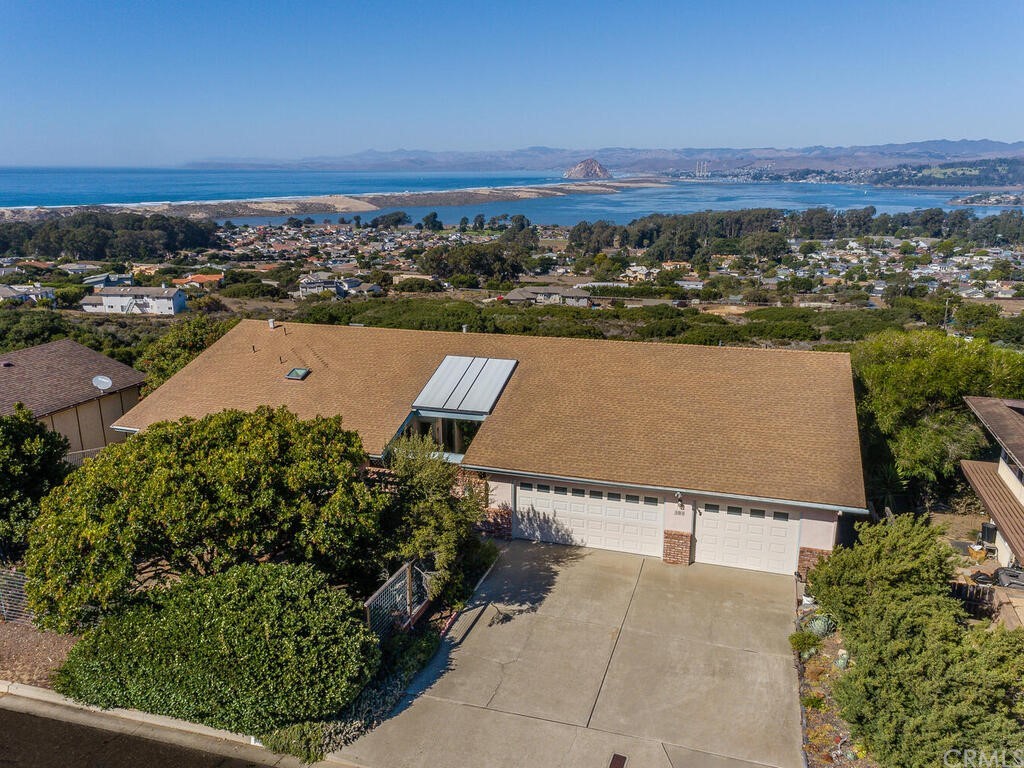 an aerial view of a house with a yard and lake view
