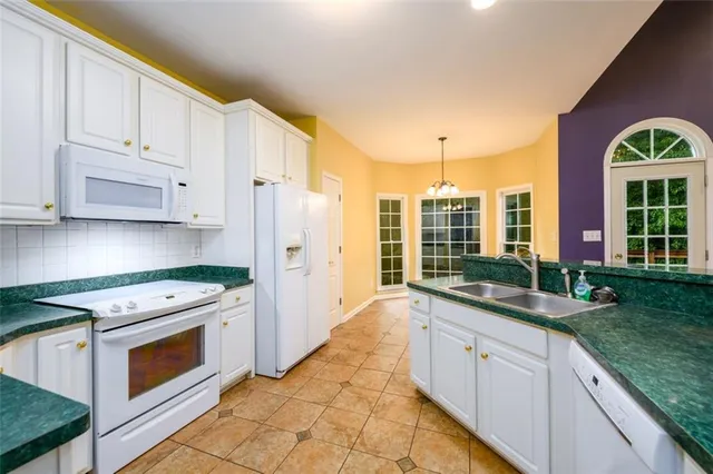 a kitchen with stainless steel appliances granite countertop a stove a sink and a granite counter tops