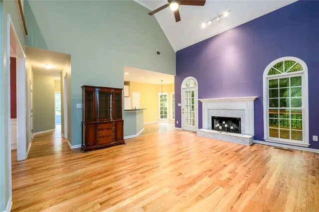 a view of an empty room with a fireplace and a window
