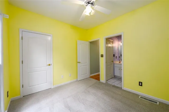 a bathroom with a sink vanity mirror and toilet