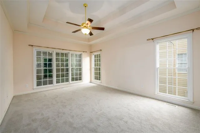 an empty room with closet and windows