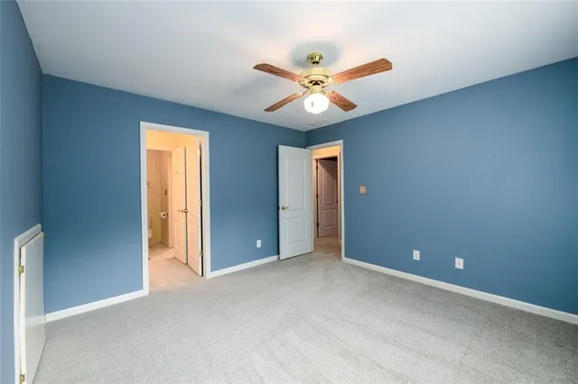a view of a room with a window and a ceiling fan
