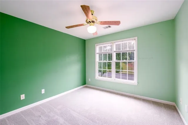 an empty room with a fan and a fan