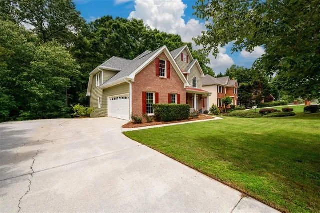 a front view of house with yard and green space