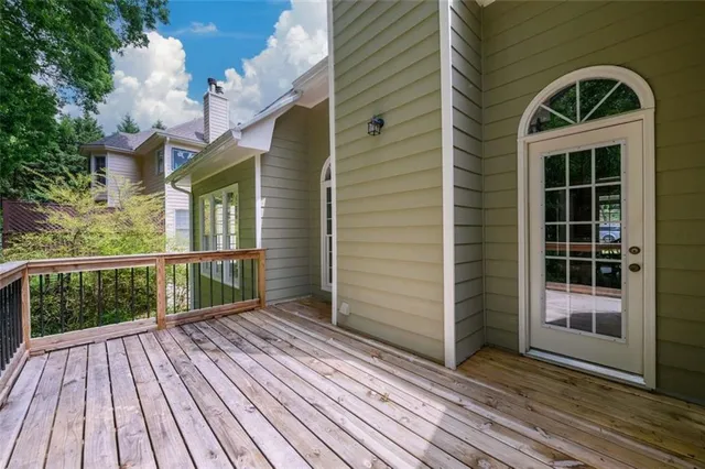 a view of balcony with wooden floor and fence
