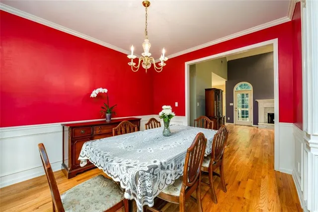 a view of a dining room with furniture and chandelier