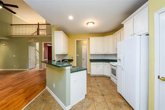 a kitchen with a refrigerator and a stove