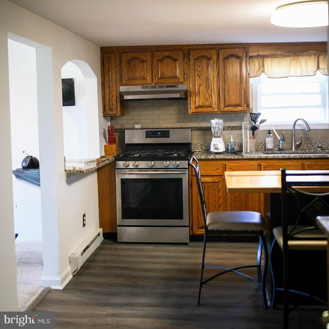 7308 Federalsburg Road Bridgeville, DE 19933 - Photo 14 of 24 a kitchen with stainless steel appliances a stove a sink and cabinets