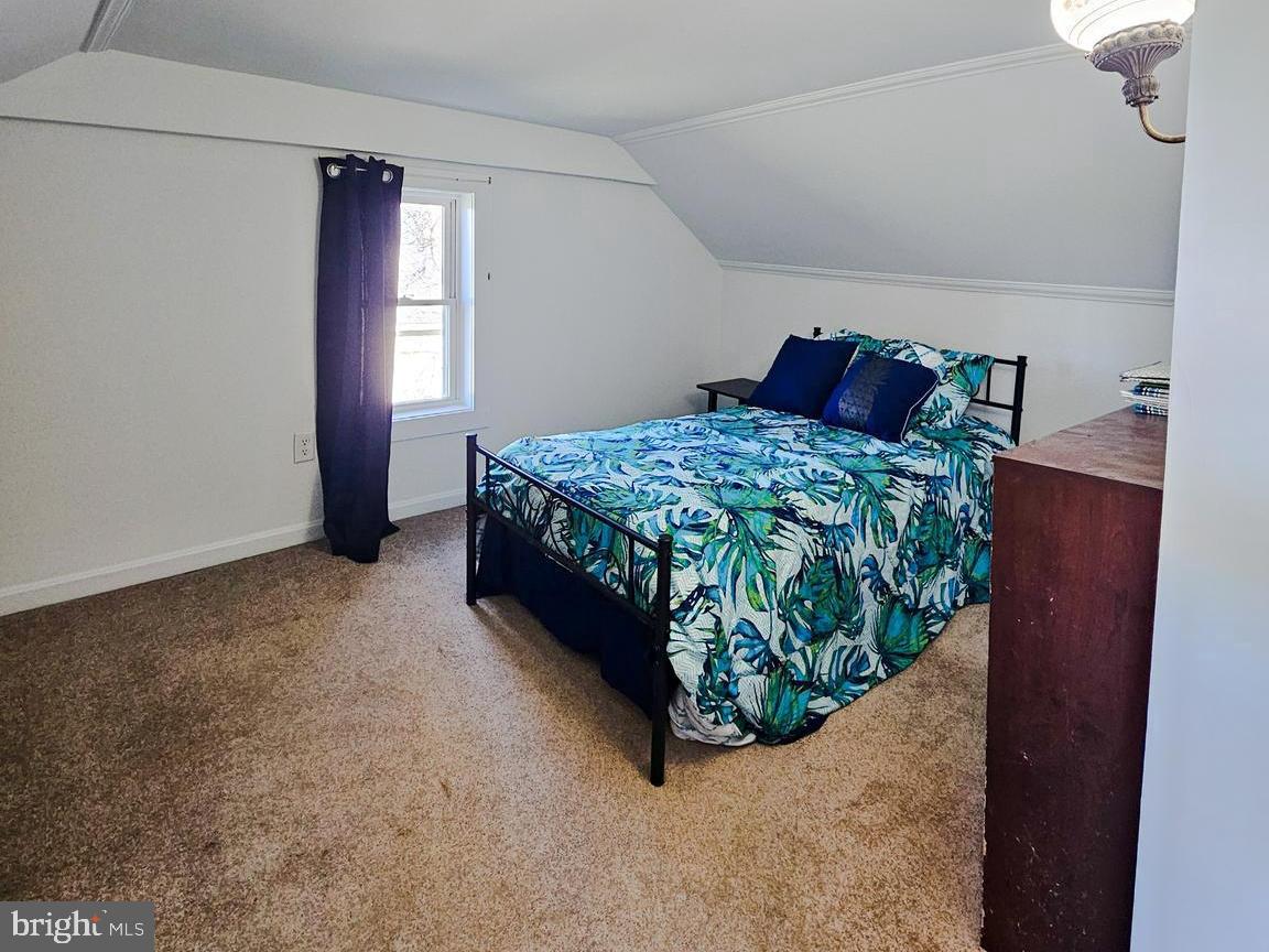 7308 Federalsburg Road Bridgeville, DE 19933 - Photo 5 of 24 a bed sitting in a bedroom next to a window and a wooden floor