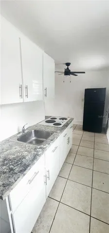 a kitchen with granite countertop a sink and a stove