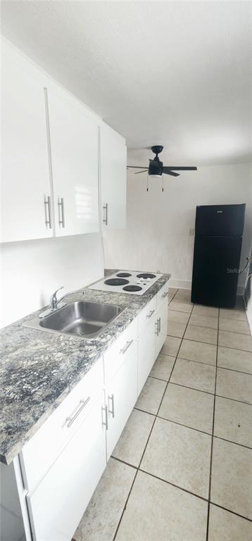 301 Ave B Southeast, Unit 4 Winter Haven, FL 33880 - Photo 1 of 16 a kitchen with granite countertop a sink and a stove