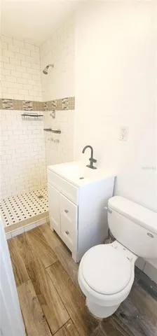 a white toilet sitting next to a bath tub