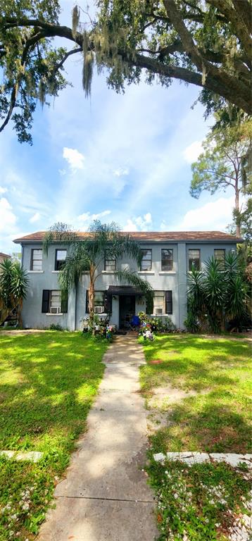 301 Ave B Southeast, Unit 4 Winter Haven, FL 33880 - Photo 16 of 16 a view of a house with a swimming pool and a big yard