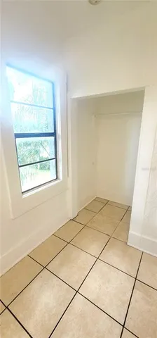 a view of a livingroom with an empty space and a window