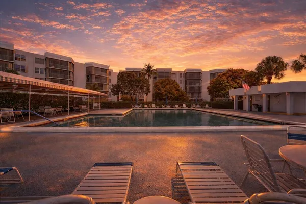 a view of a swimming pool with outdoor seating