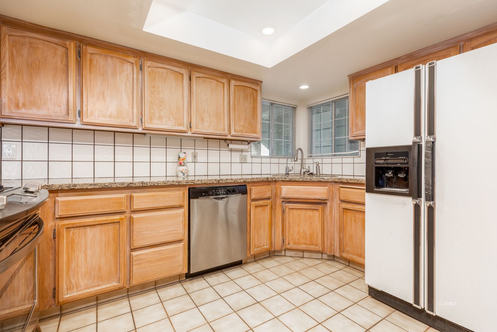 528 Amanda Street Ridgecrest, CA 93555 - Photo 10 of 30 a kitchen with stainless steel appliances granite countertop a stove a sink and a refrigerator