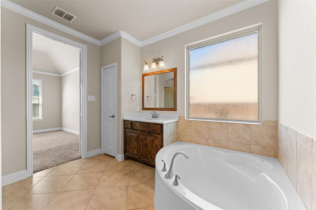 1425 Barrolo Drive McLendon-Chisholm, TX 75032 - Photo 23 of 38 a bathroom with a tub sink and mirror