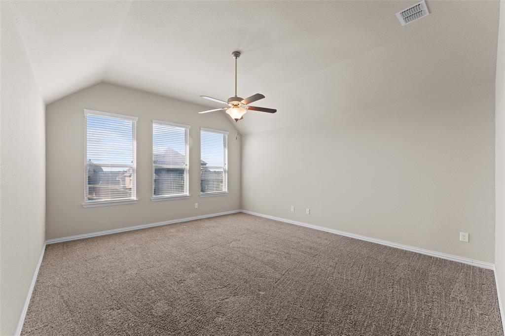 1425 Barrolo Drive McLendon-Chisholm, TX 75032 - Photo 29 of 38 en empty room with windows and chandelier